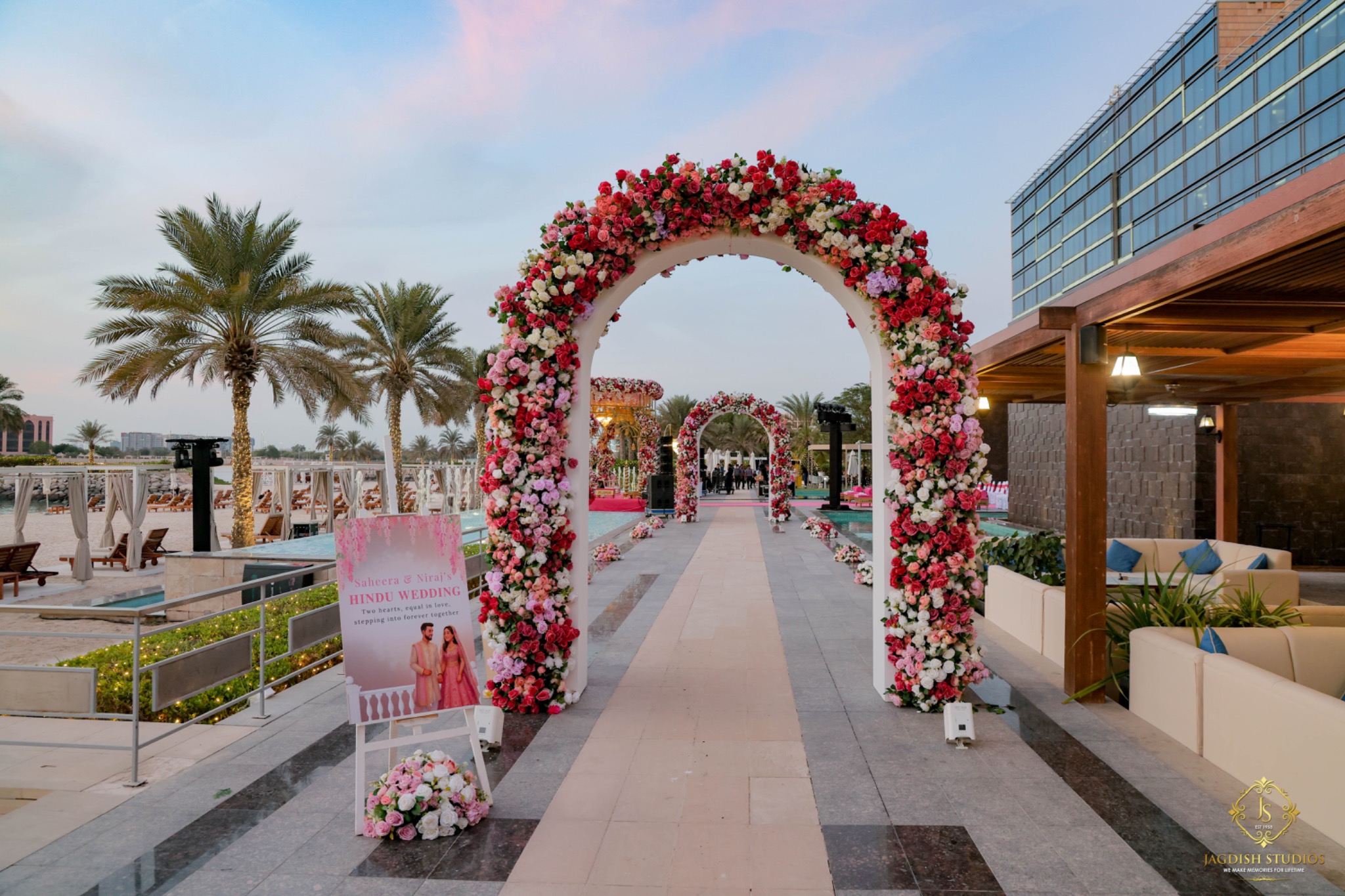Pink floral wedding arches at a luxury outdoor celebration