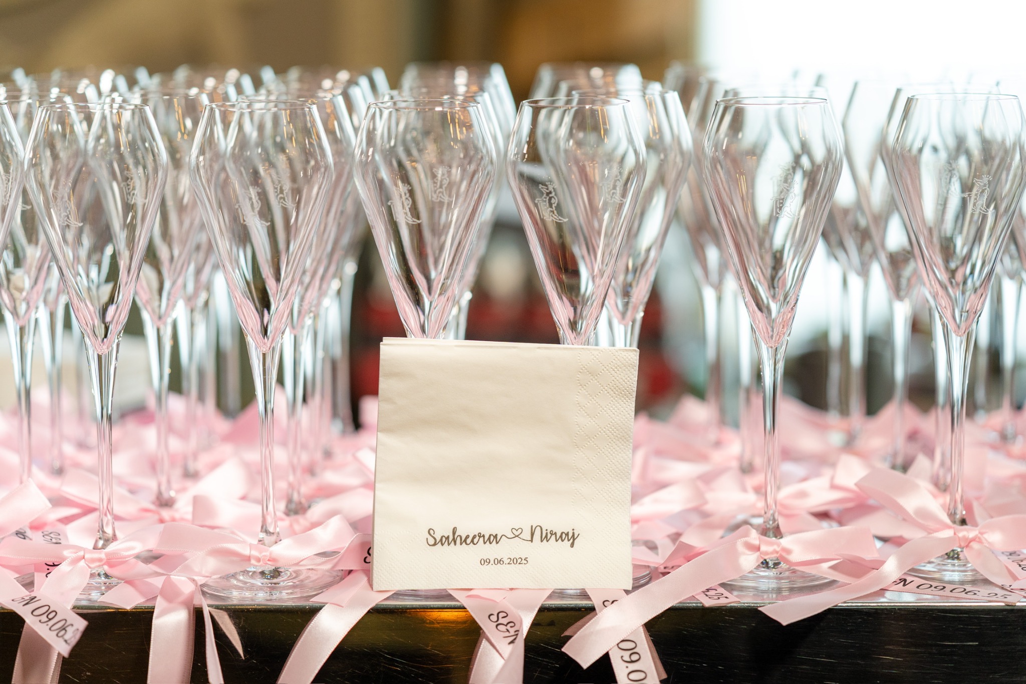 Personalised champagne glasses finished with pink ribbon
