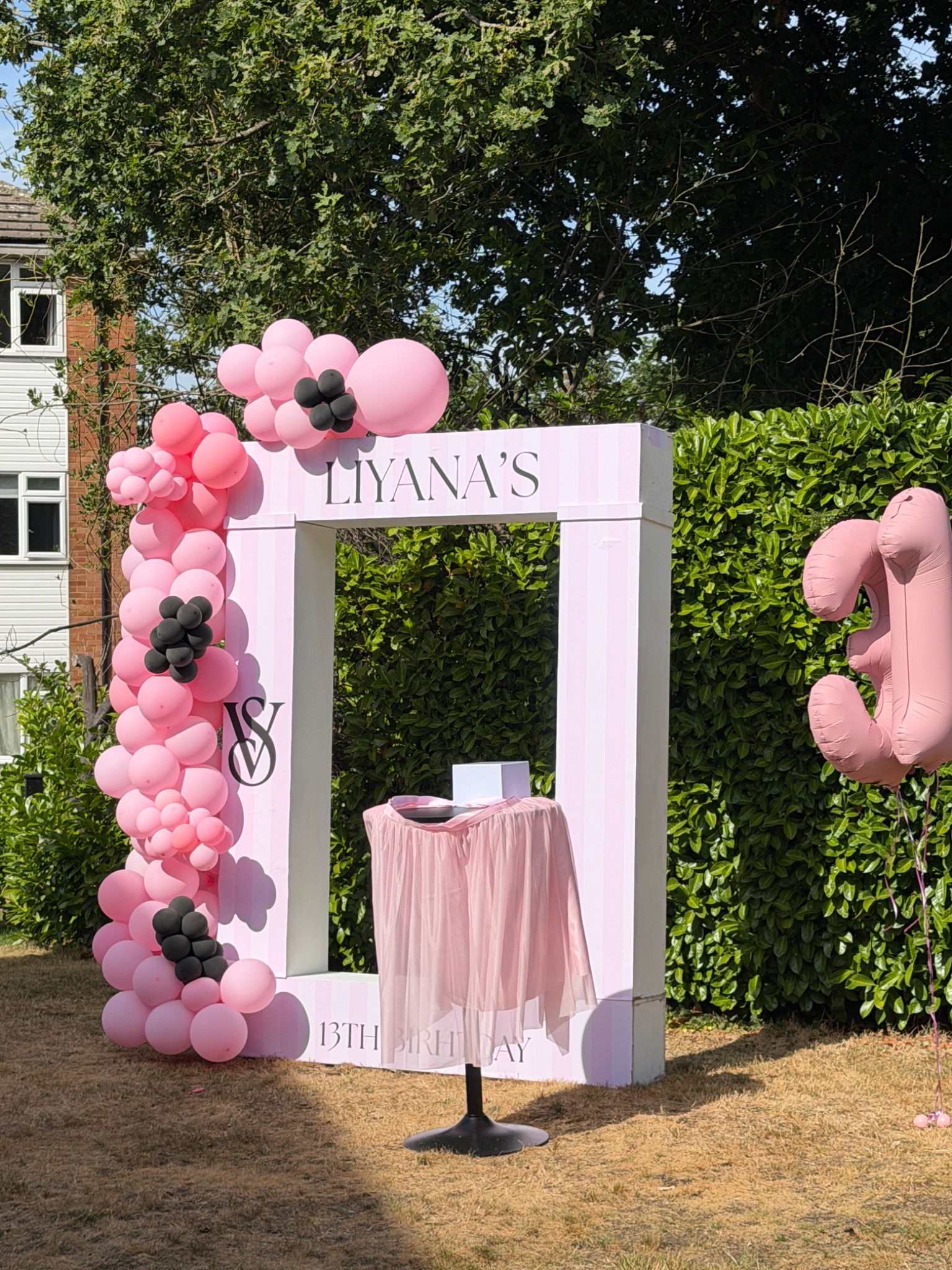Pink birthday party installation and balloons